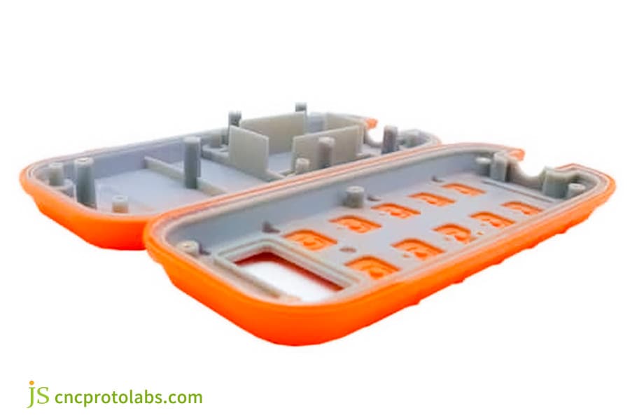 Insert molded orange plastic automotive housing.