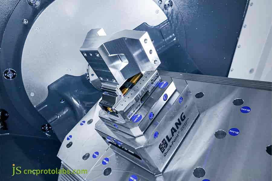 A specialized vise 5 axis​ clamping a metal part.