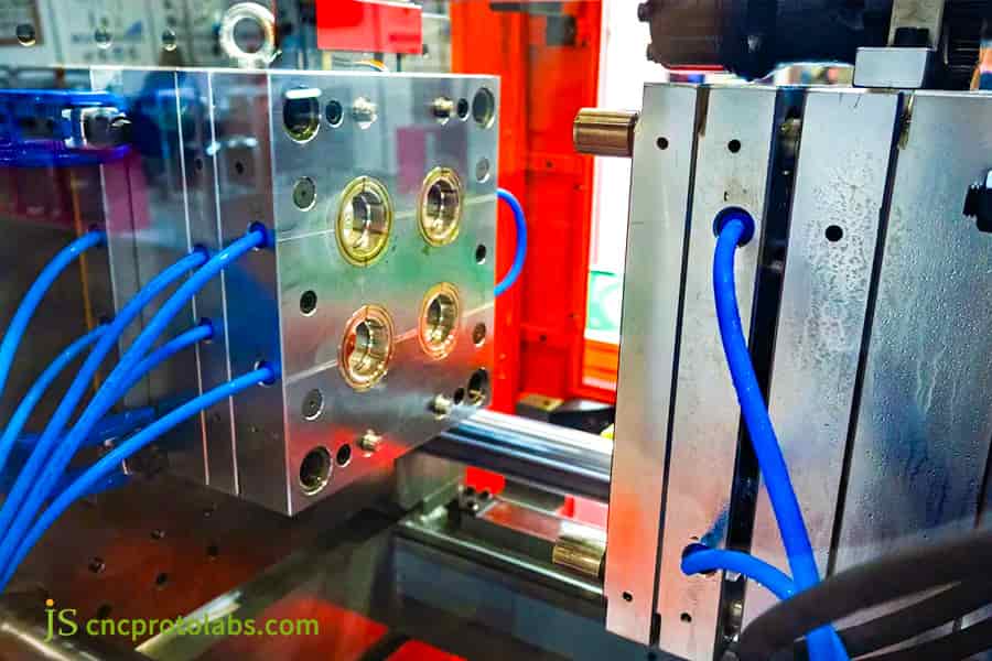 High precision injection mold with blue hoses.