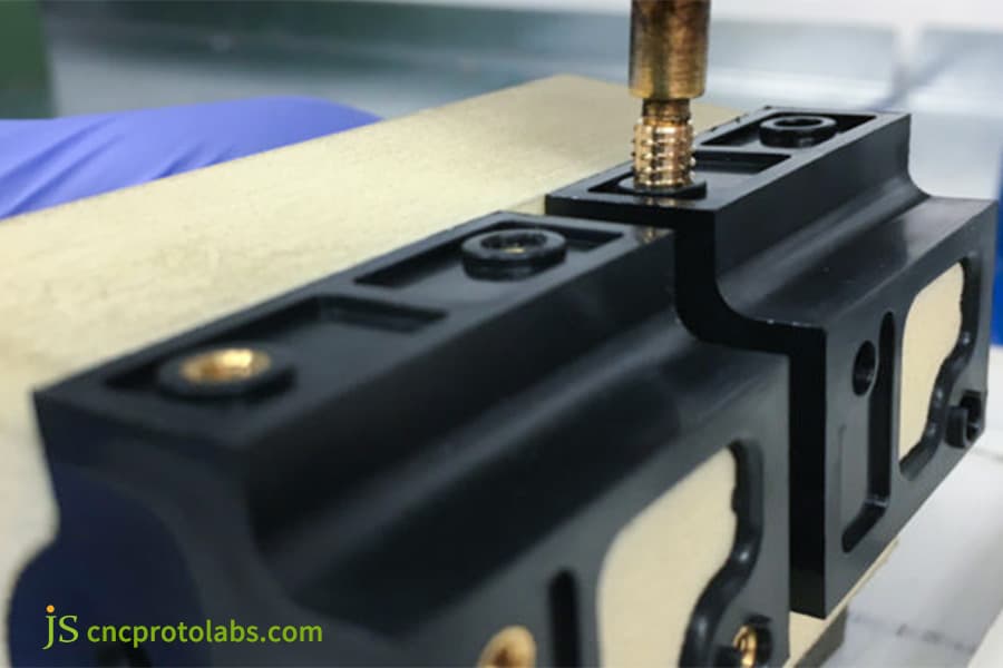 A threaded metal insert molded​ into substrate